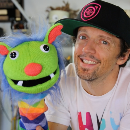 Jason Mraz with a puppet announcing Shine production