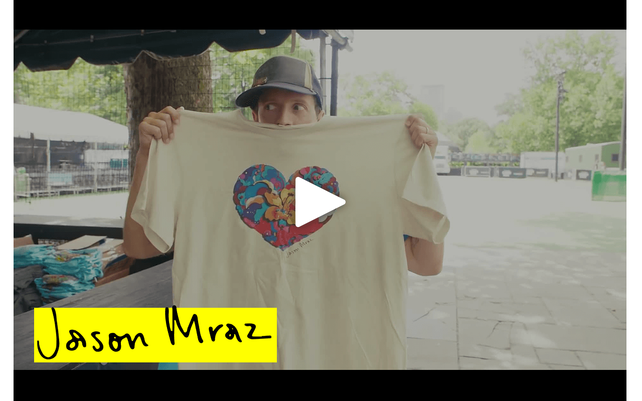 Jason Mraz holding up a t-shirt made out of recycled t-shirts